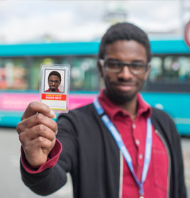 Picture of our student, David, holding his bus pass