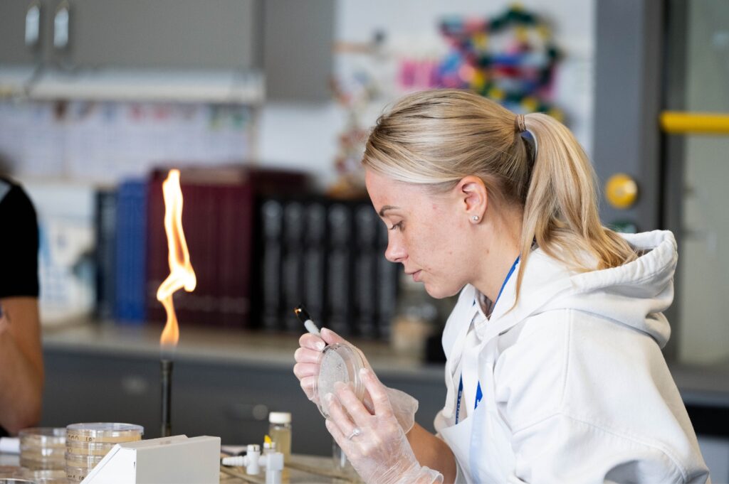 Female student writing on a sample