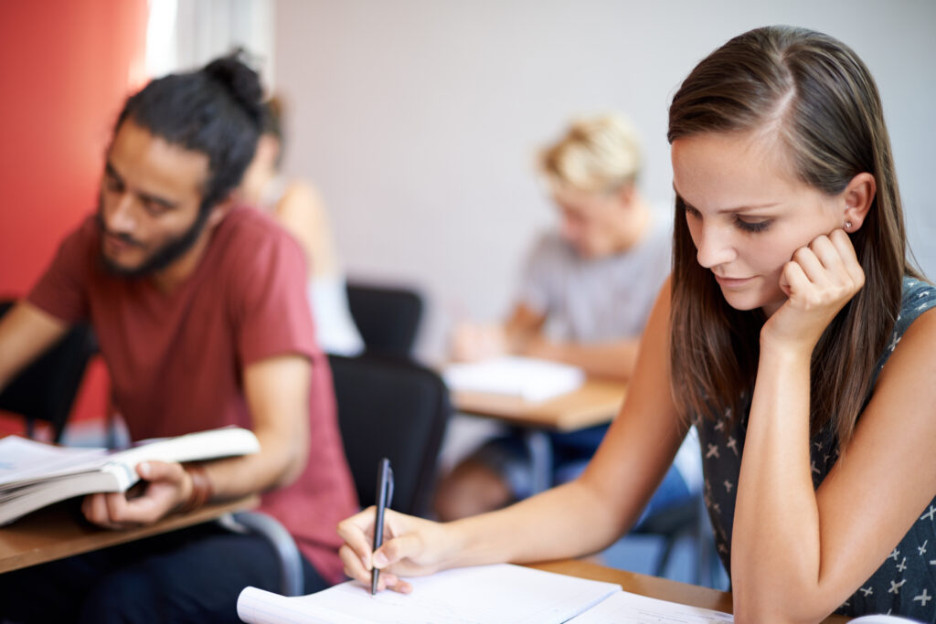 Female student writing on a piece of paper