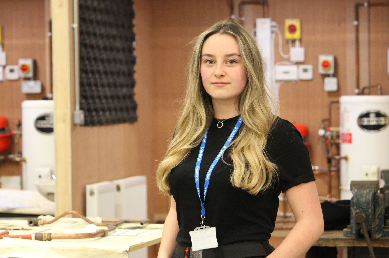 Female apprentice in plumbing workshop