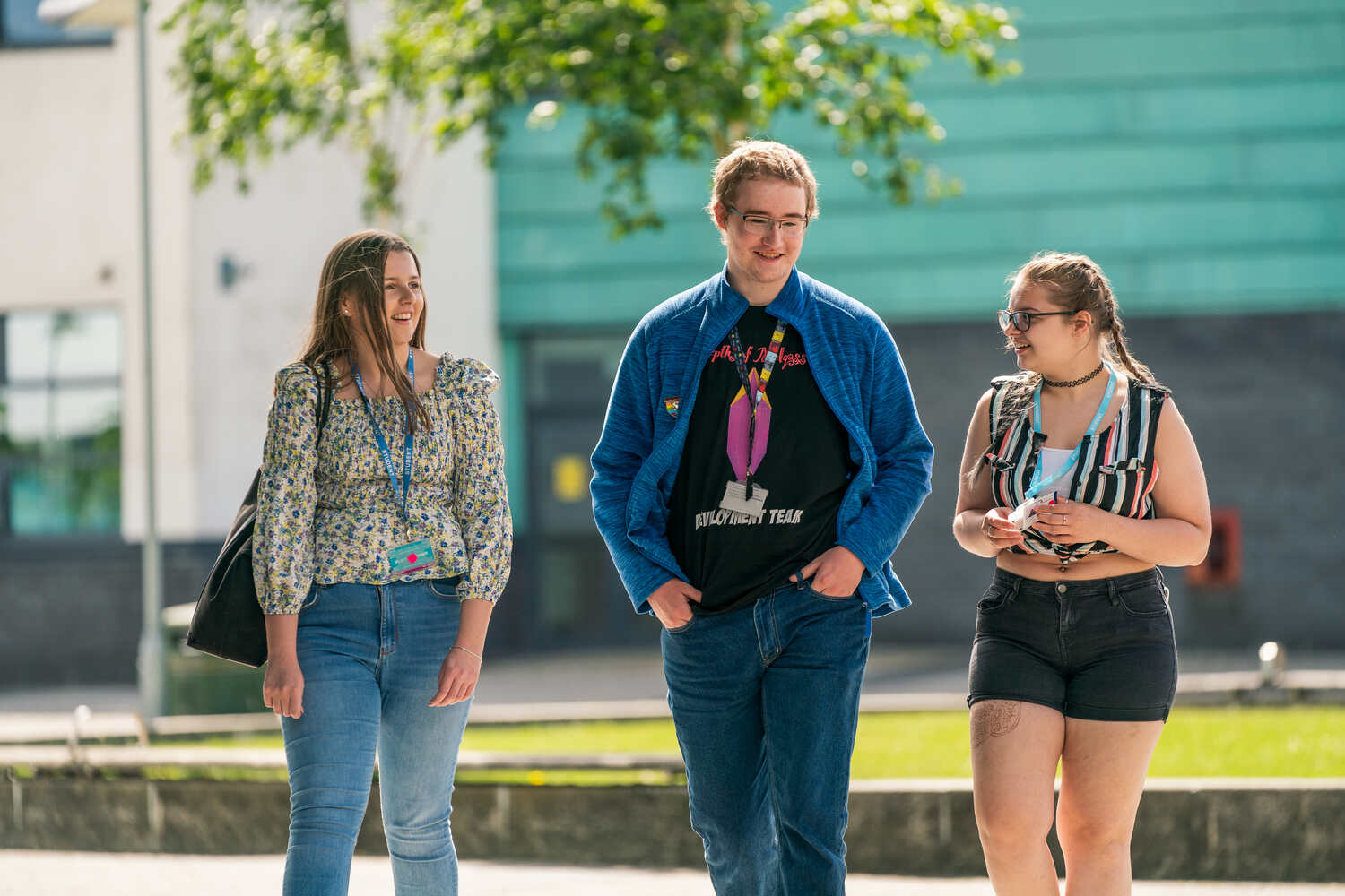 three students walking outside St Helens College