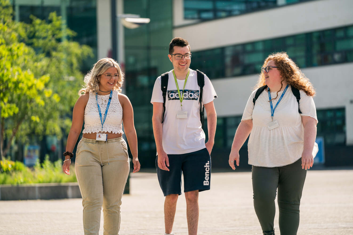 three students walking outside St Helens College