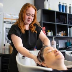 hairdressing student washing a clients hair