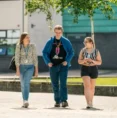 three students walking outside st helens college